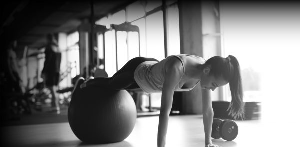 A woman working out on pilates ball