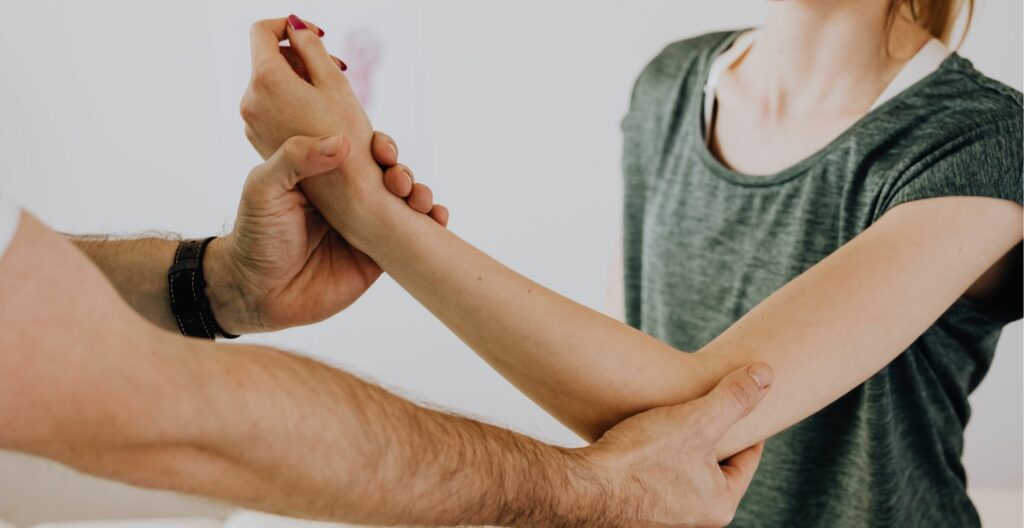 chiropractor helping woman with arm issues