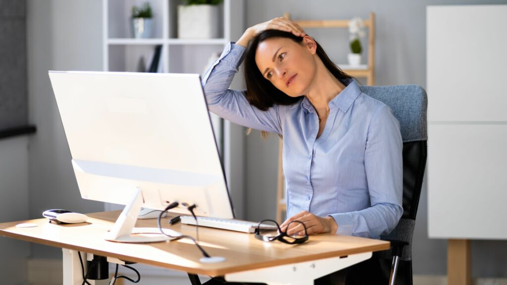 stretching neck at desk