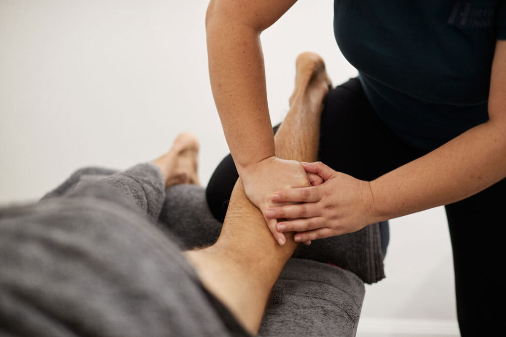 Massage Therapist performing deep tissue massage
