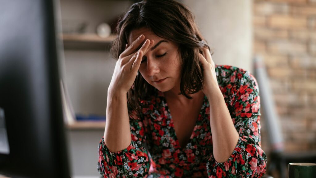 woman suffering from a headache at her desk