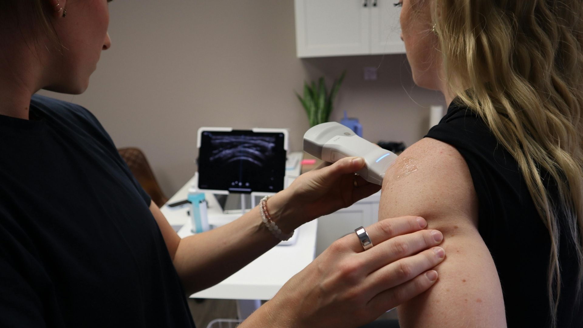 woman receiving an ultrasound on her shoulder 
