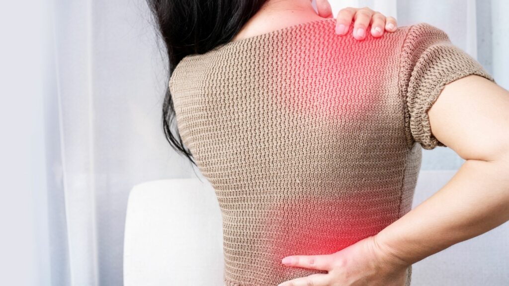 woman experiencing pain in shoulder and lower back