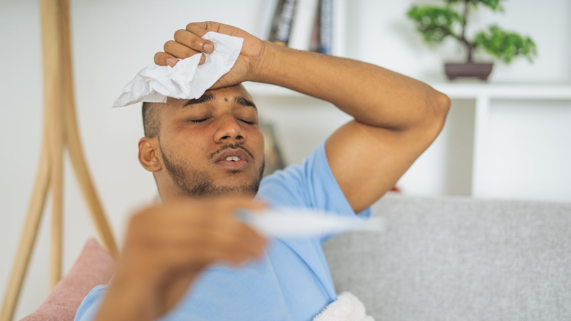 man suffering from a fever with backache